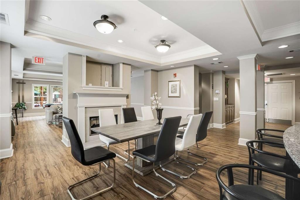 3275 Lenox Road Northeast, Unit 302 Atlanta, GA 30324 - Photo 36 of 50 a living room with furniture a fireplace and wooden floor