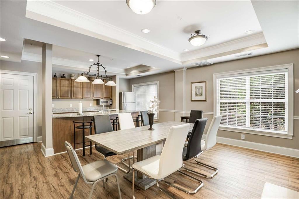 3275 Lenox Road Northeast, Unit 302 Atlanta, GA 30324 - Photo 37 of 50 a view of a dining room with furniture window and wooden floor