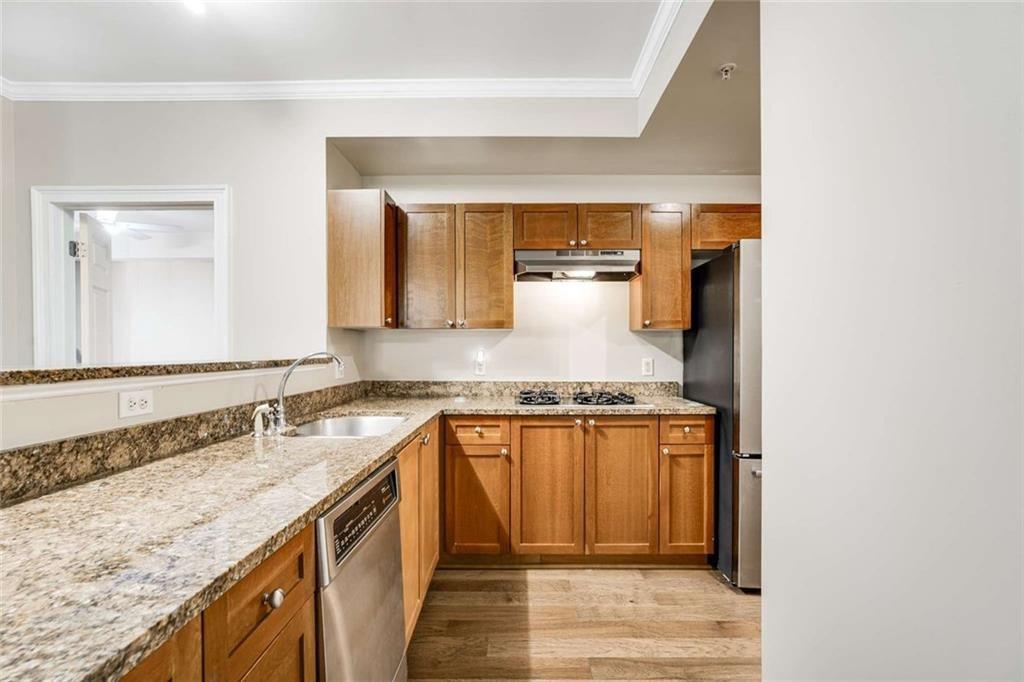 3275 Lenox Road Northeast, Unit 302 Atlanta, GA 30324 - Photo 8 of 50 a kitchen with granite countertop a sink and a stove