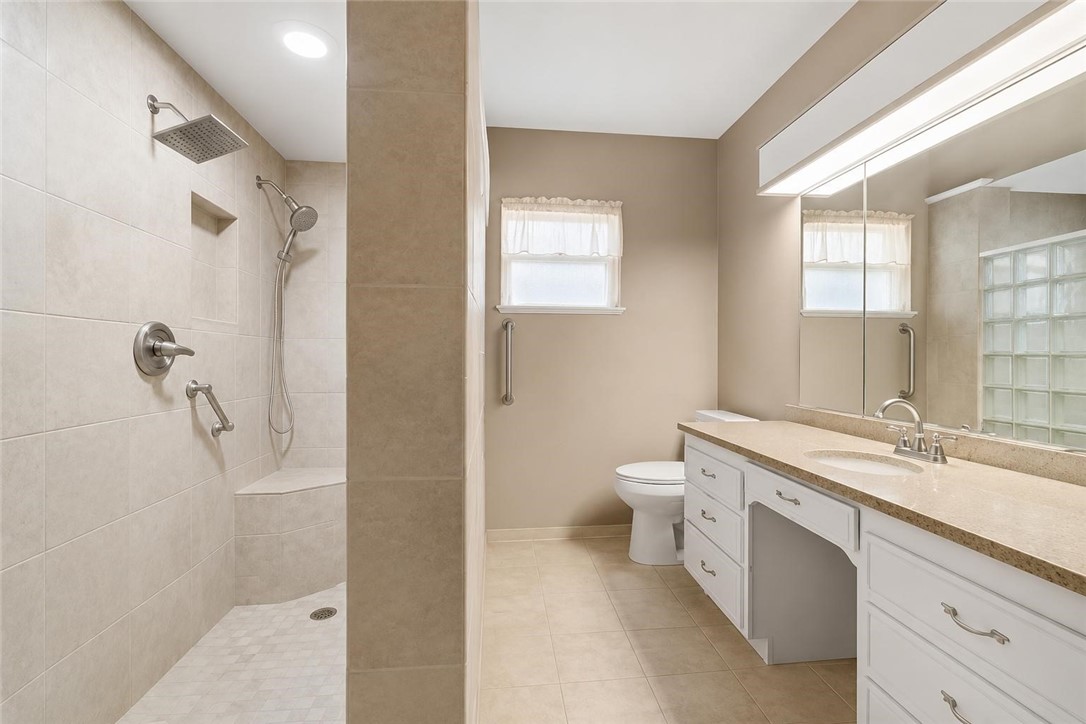 9675 County Road 325 Mathis, TX 78368 - Photo 21 of 29 a bathroom with a granite countertop sink a toilet and shower