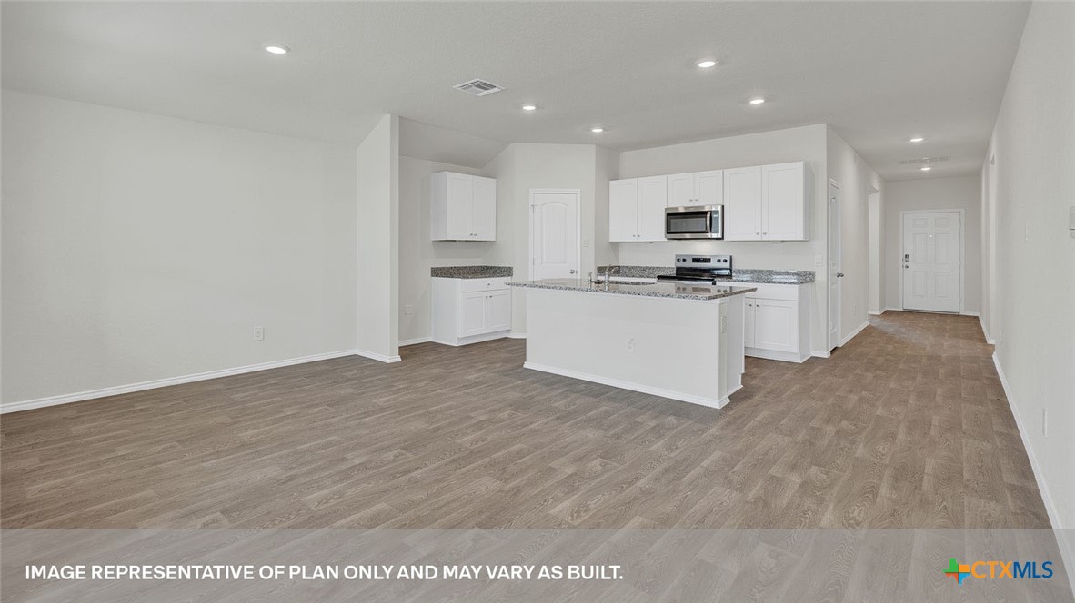 418 Hodges Street Maxwell, TX 78656 - Photo 19 of 32 a kitchen with stainless steel appliances granite countertop a stove top oven a sink and a refrigerator