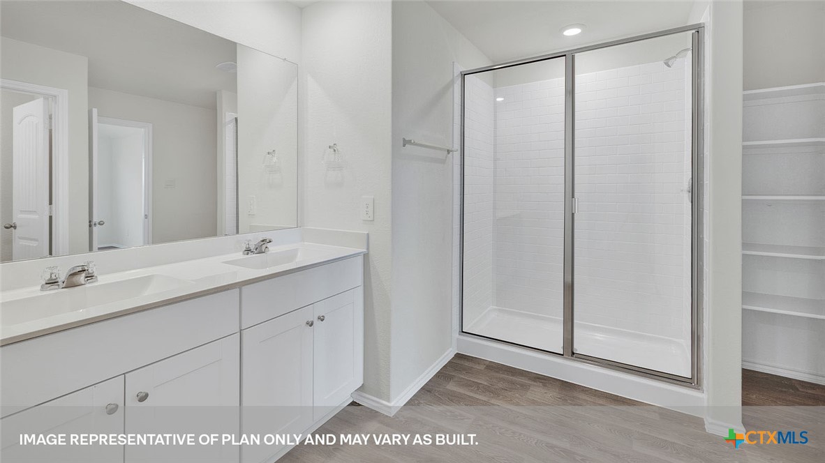 418 Hodges Street Maxwell, TX 78656 - Photo 22 of 32 a bathroom with a double vanity sink and mirror