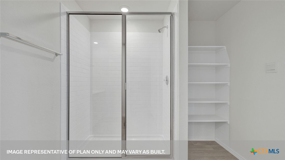 418 Hodges Street Maxwell, TX 78656 - Photo 23 of 32 a bathroom with a glass shower door