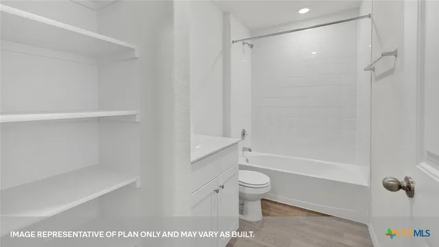 a kitchen with stainless steel appliances granite countertop a stove a sink a refrigerator a microwave and white cabinets