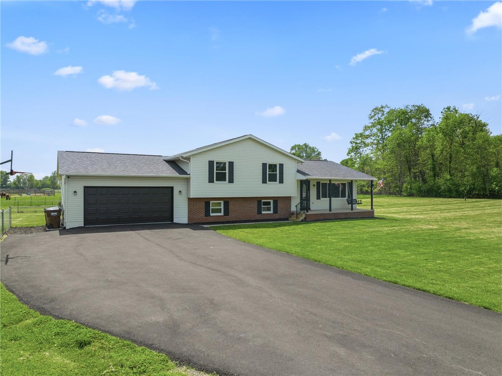 1353 Foust Road Xenia, OH 45385 - Photo 2 of 50 This residence features a split-level design, attached garage, and a welcoming front porch.