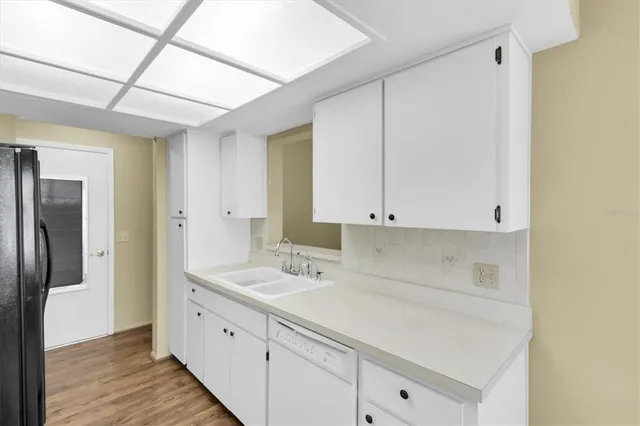a utility room with cabinets washer and dryer