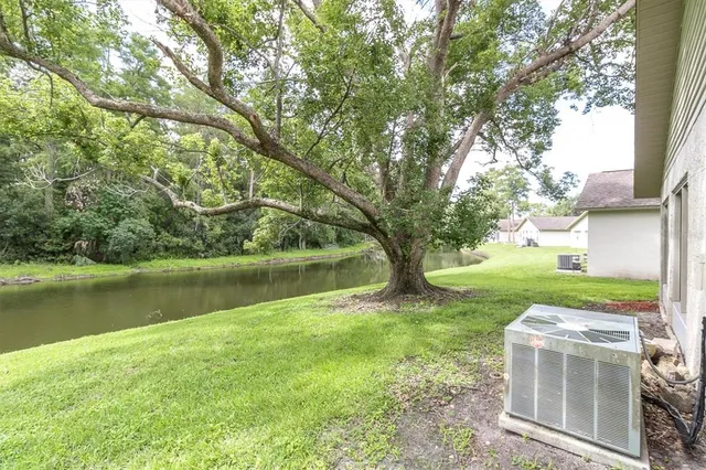 a view of a house with backyard and sitting area