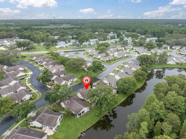 an aerial view of residential houses with outdoor space and swimming pool