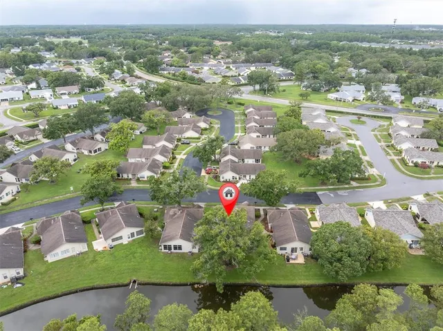 an aerial view of a house with a yard basket ball court and outdoor seating