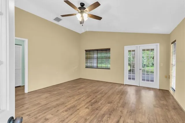 wooden floor in an empty room with a window