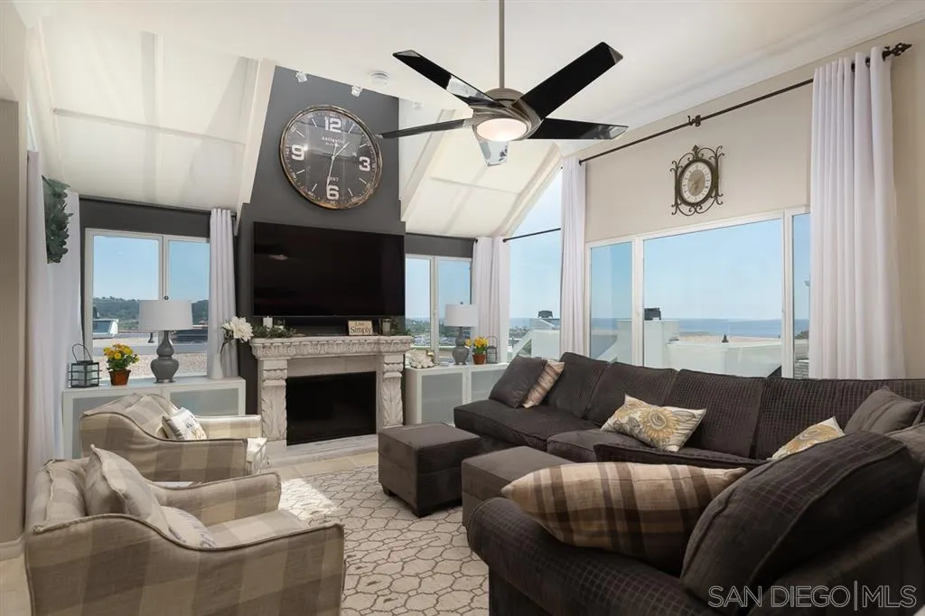 323 Shoemaker Lane Solana Beach, CA 92075 - Photo 2 of 25 a living room with furniture a flat screen tv and a fireplace