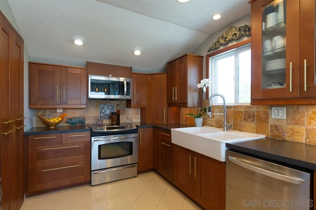323 Shoemaker Lane Solana Beach, CA 92075 - Photo 6 of 25 a kitchen with a sink stove and refrigerator