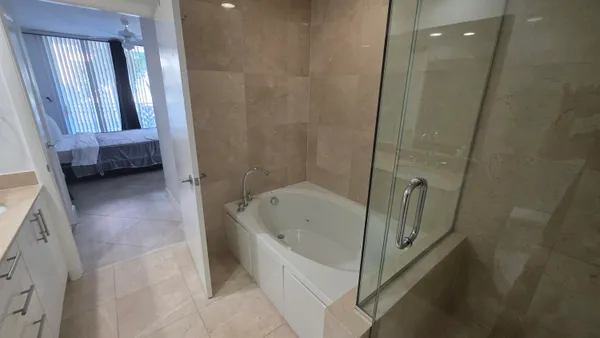 a bathroom with a tub a sink and a shower