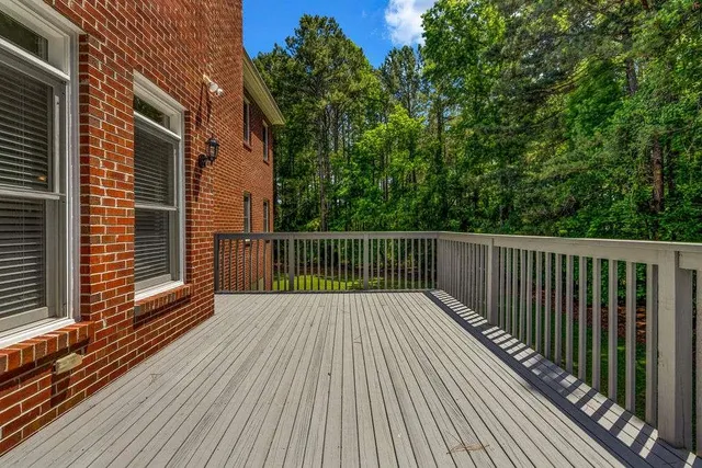 a aerial view of a house with swimming pool next to a big yard