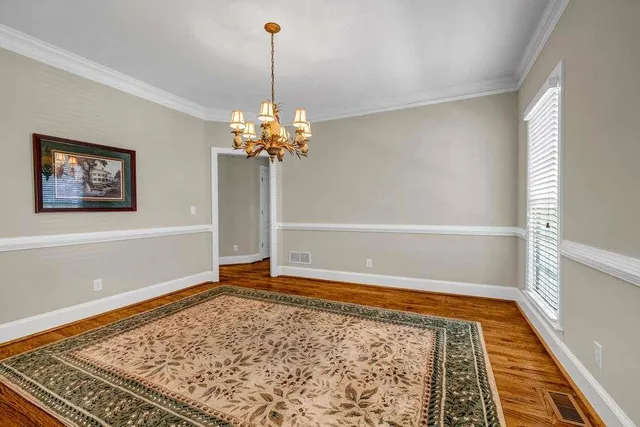 a view of a livingroom with wooden floor and stairs