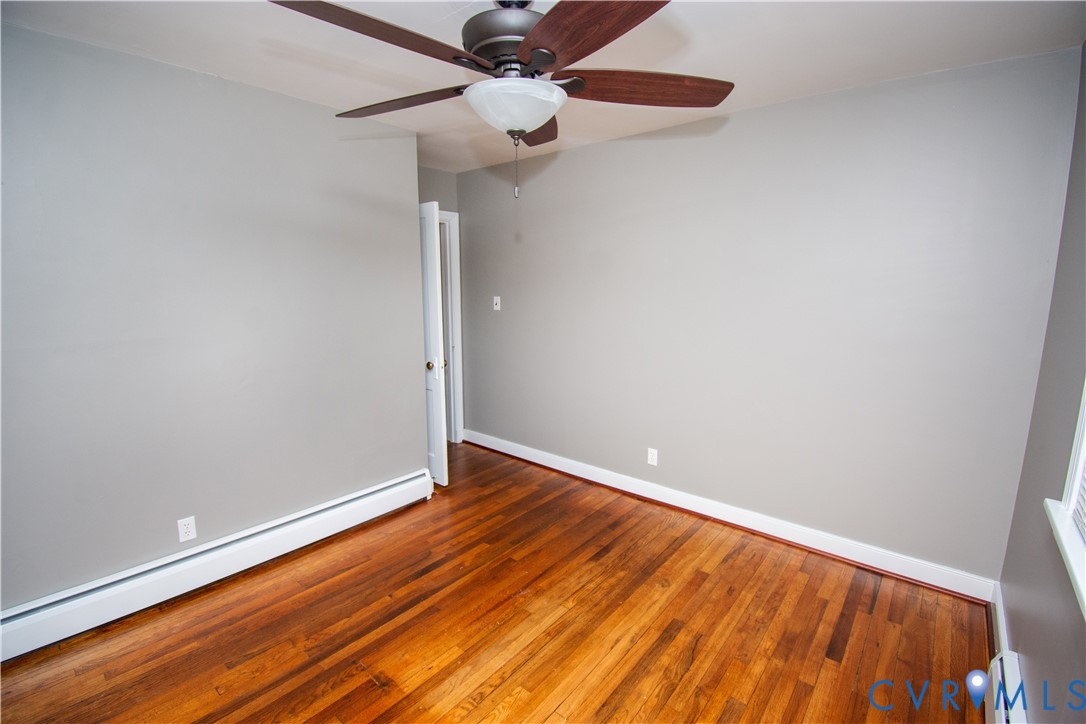 6800 Three Chopt Road Richmond, VA 23226 - Photo 8 of 26 Hardwood flooring, light gray wall paint, ceiling