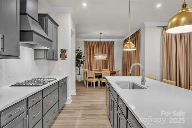 a kitchen with sink refrigerator and cabinets