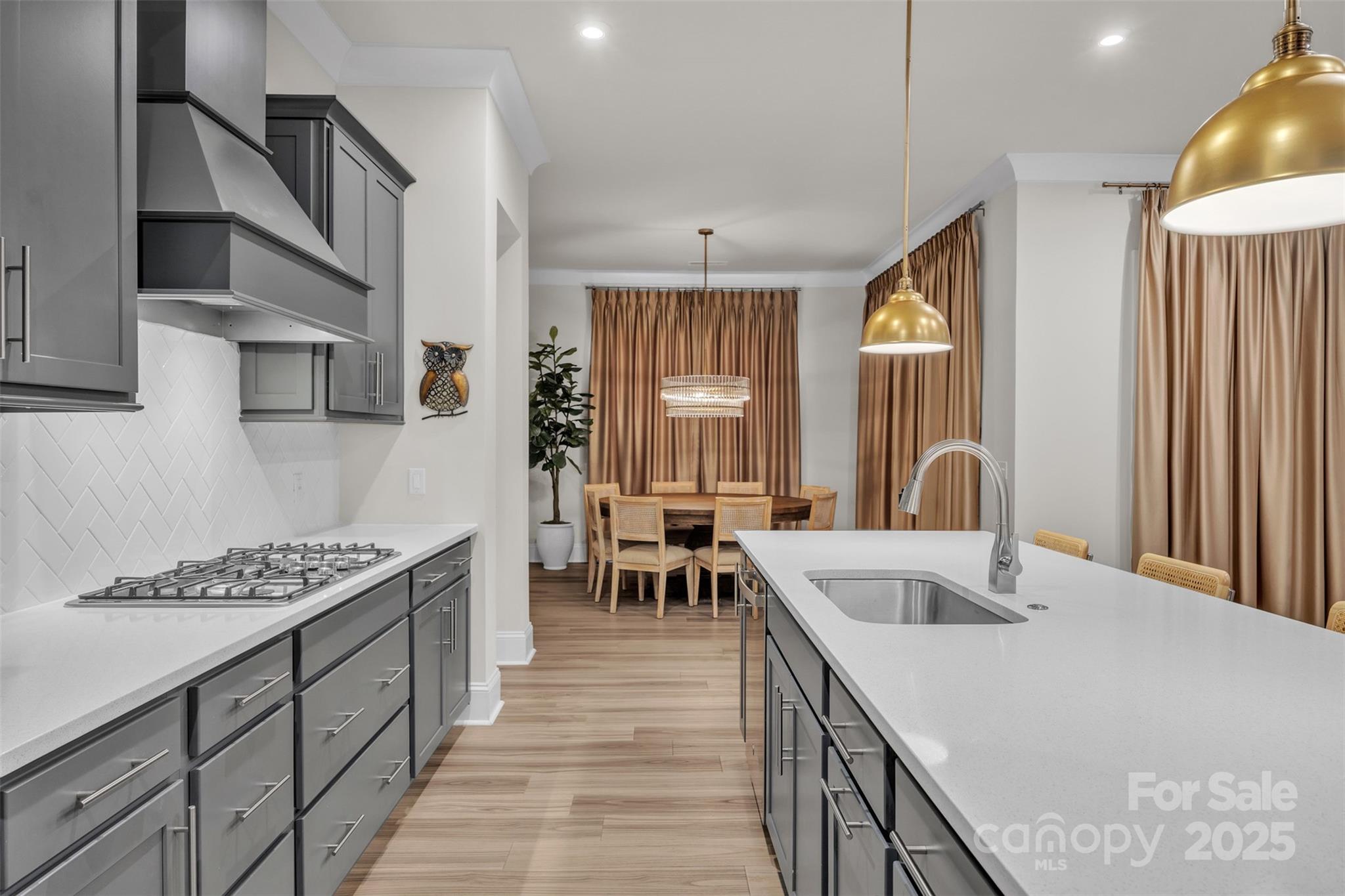 a kitchen with sink refrigerator and cabinets