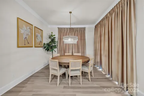 a dining room with furniture window and wooden floor