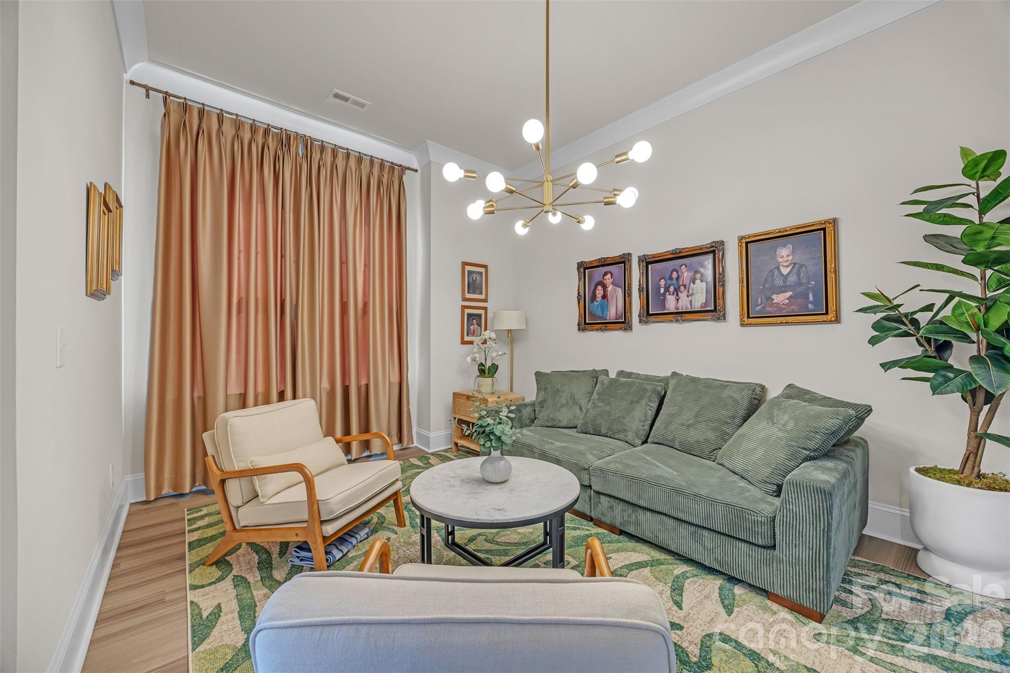 513 Meadow Ridge Drive Belmont, NC 28012 - Photo 13 of 40 a living room with furniture and a chandelier
