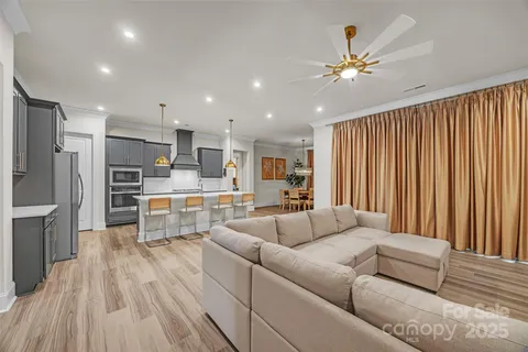 a living room with furniture and kitchen view