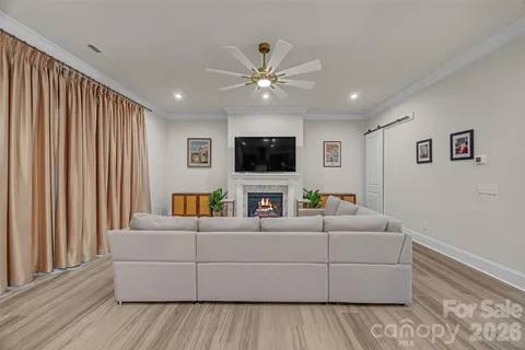 a living room with furniture and kitchen view