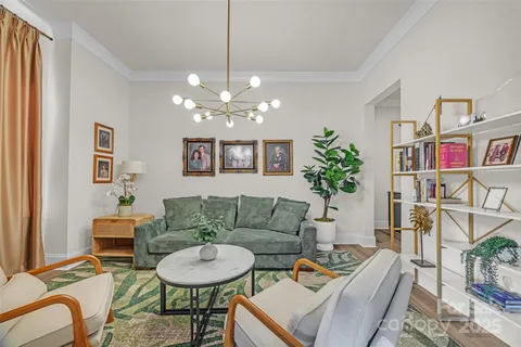 a living room with furniture and a chandelier