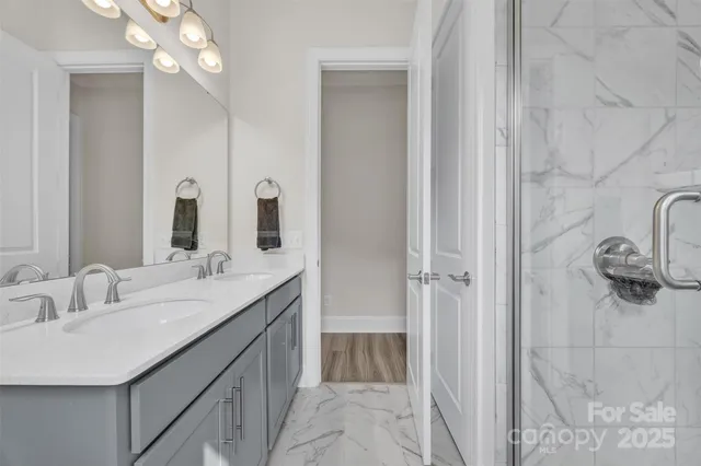 a bathroom with a double vanity sink and mirror