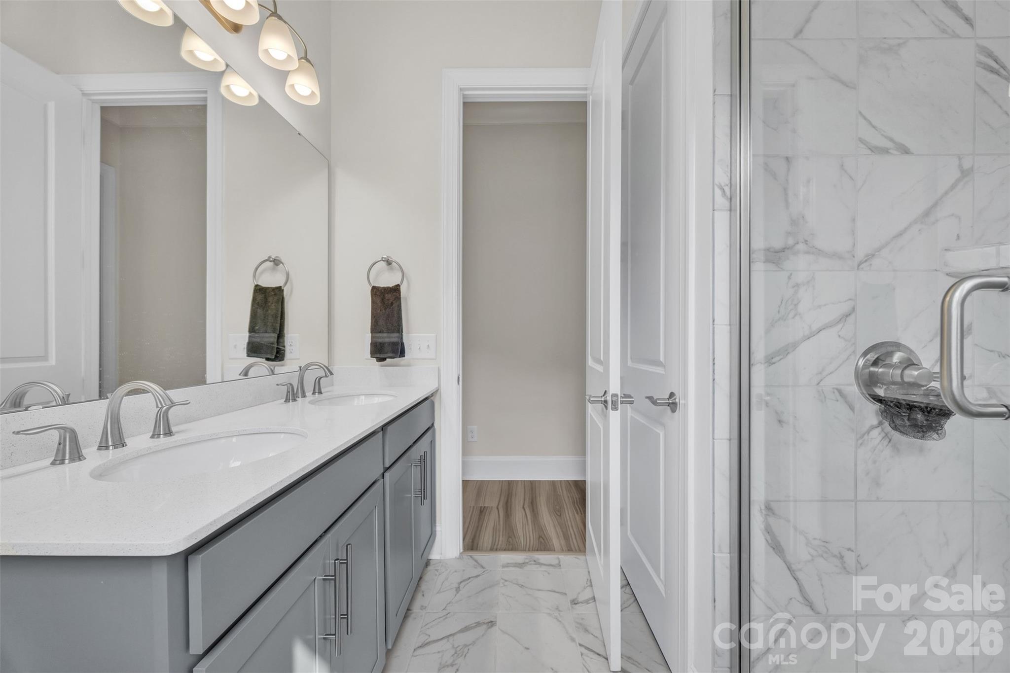 513 Meadow Ridge Drive Belmont, NC 28012 - Photo 22 of 40 a bathroom with a double vanity sink and mirror