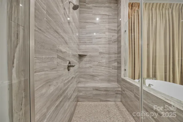 a bathroom with bathtub and shower