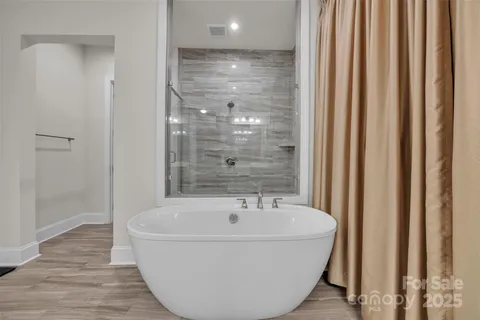 a bathroom with a tub and shower
