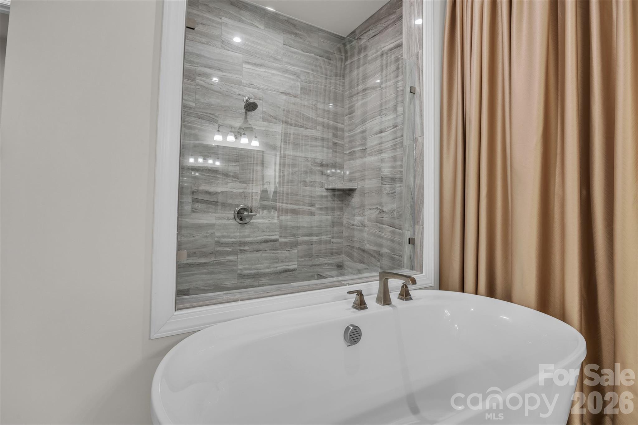 513 Meadow Ridge Drive Belmont, NC 28012 - Photo 28 of 40 a bathroom with a tub and shower