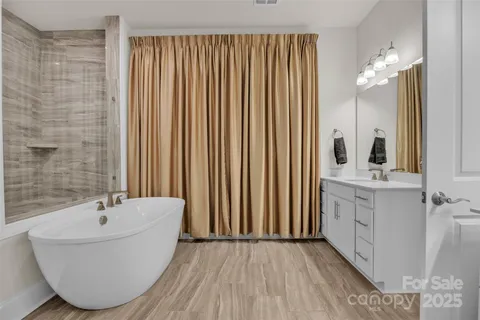 a bathroom with double vanity sink and a mirror