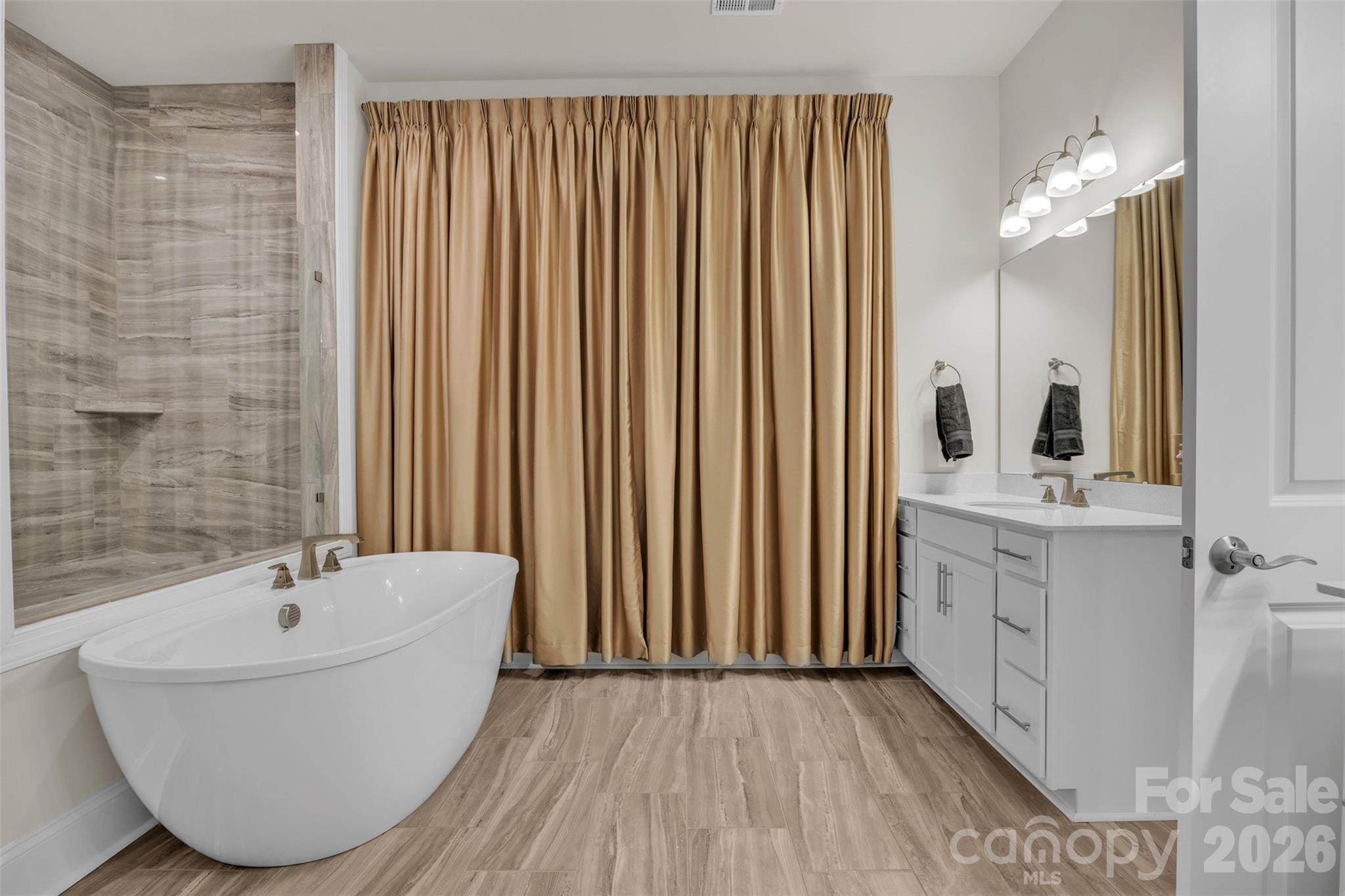 513 Meadow Ridge Drive Belmont, NC 28012 - Photo 29 of 40 a bathroom with a bathtub and shower