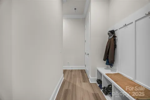 a view of a livingroom with wooden floor and windows