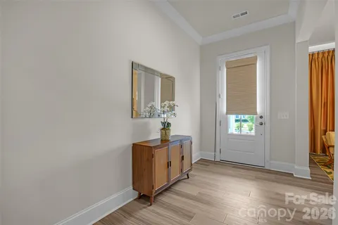 a bedroom with a bed lamp and a large window
