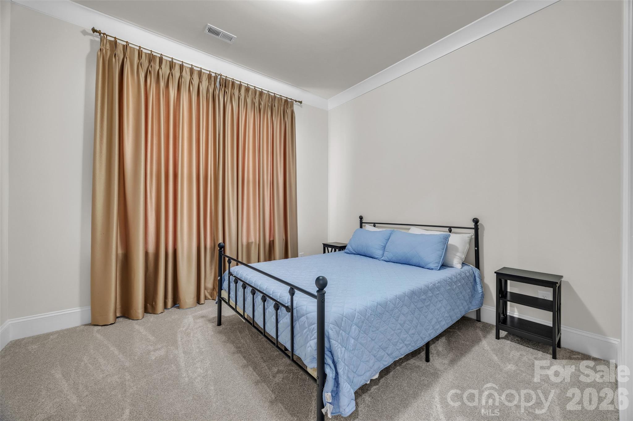 513 Meadow Ridge Drive Belmont, NC 28012 - Photo 34 of 40 a bedroom with a bed lamp and a large window