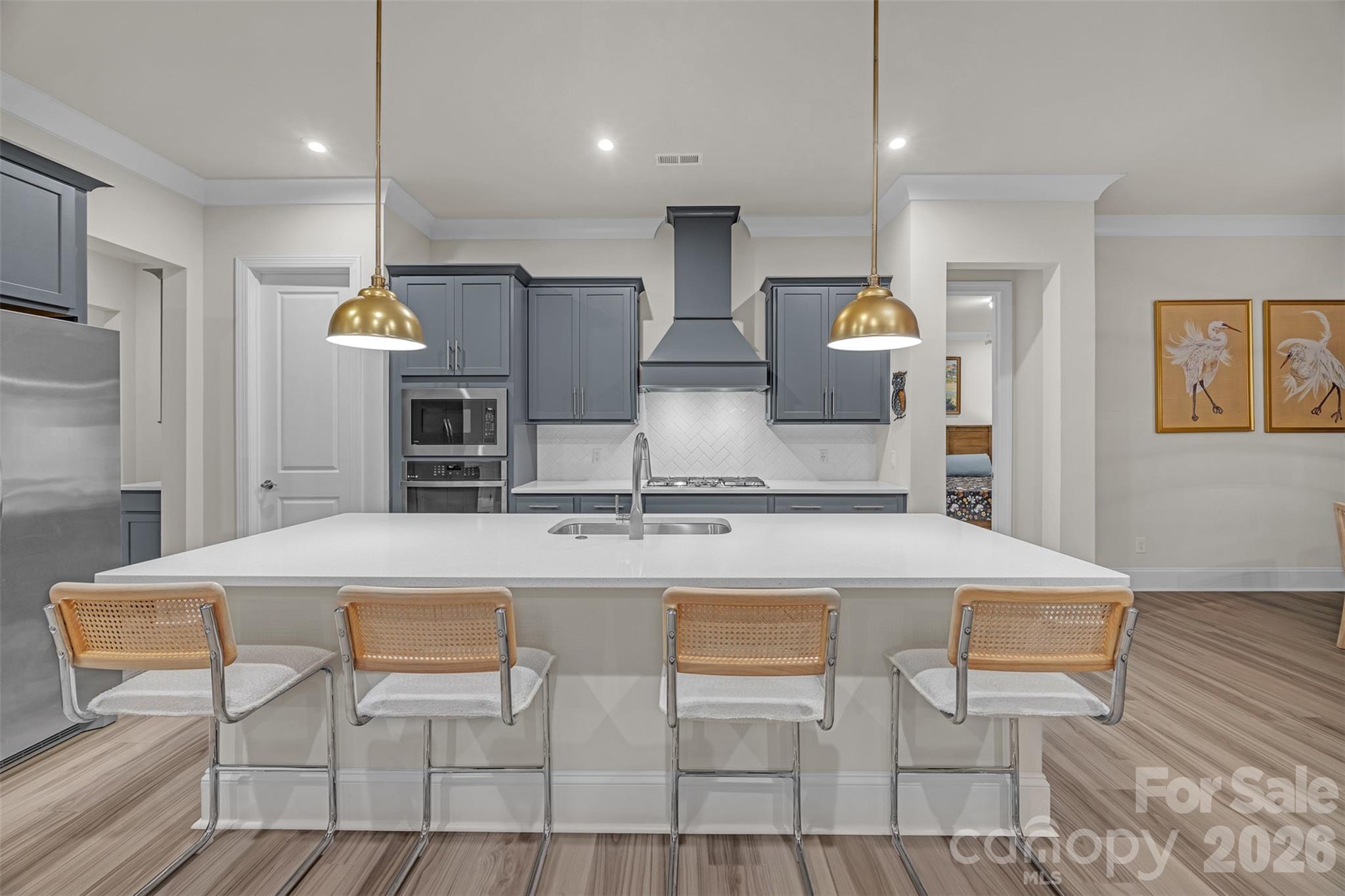513 Meadow Ridge Drive Belmont, NC 28012 - Photo 6 of 40 a kitchen with kitchen island a stove a table and chairs in it