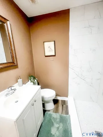 a bathroom with a sink toilet and tub