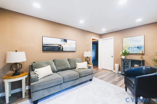 a living room with furniture and a lamp