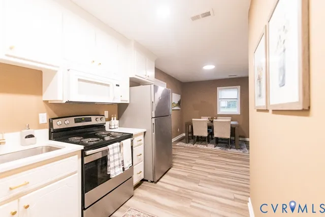 a kitchen with a refrigerator stove and sink