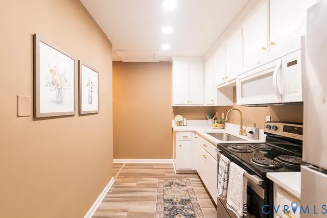 a kitchen with a stove and a white cabinet