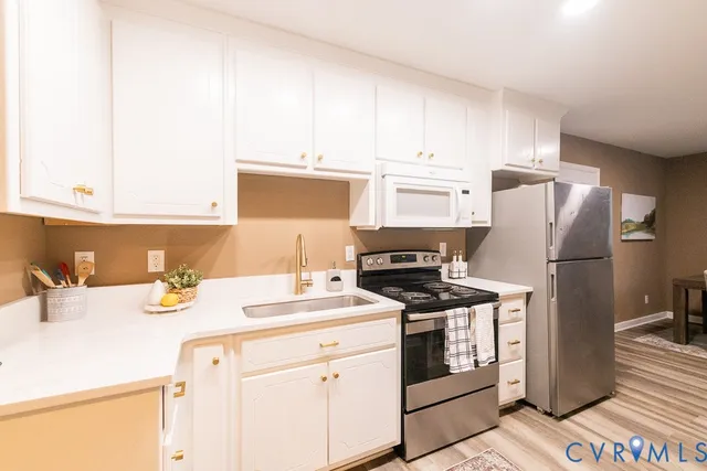 a kitchen with a sink stove and refrigerator