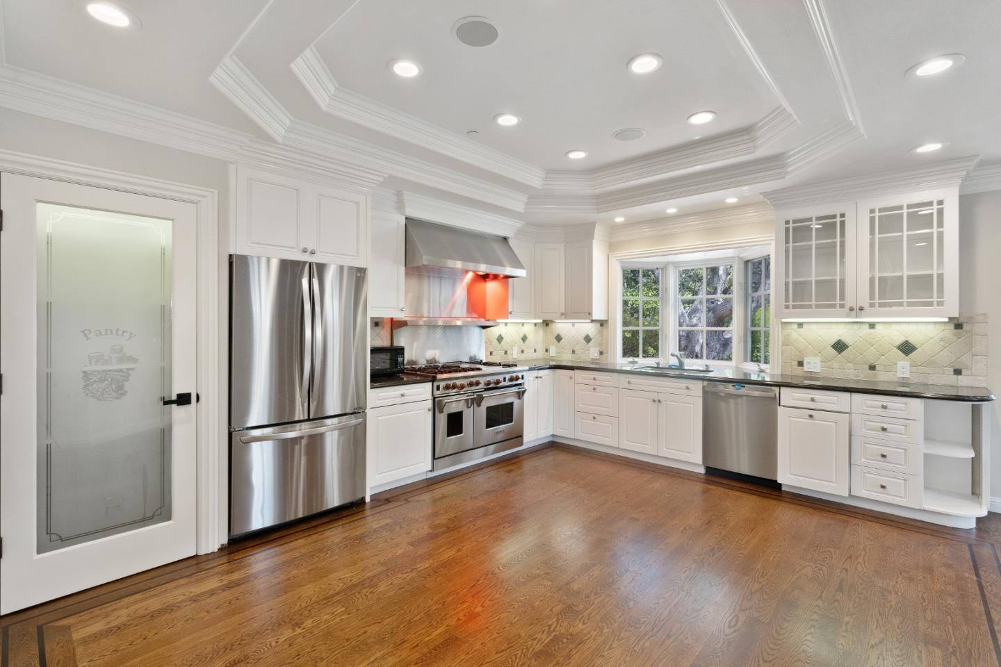 612 Prospect Row San Mateo, CA 94401 - Photo 16 of 54 a large kitchen with stainless steel appliances lot a large counter top and a refrigerator