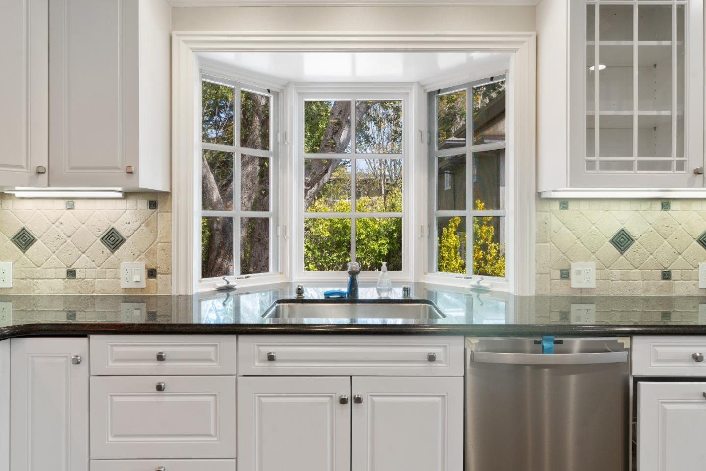 612 Prospect Row San Mateo, CA 94401 - Photo 17 of 54 a kitchen with granite countertop white cabinets and a window