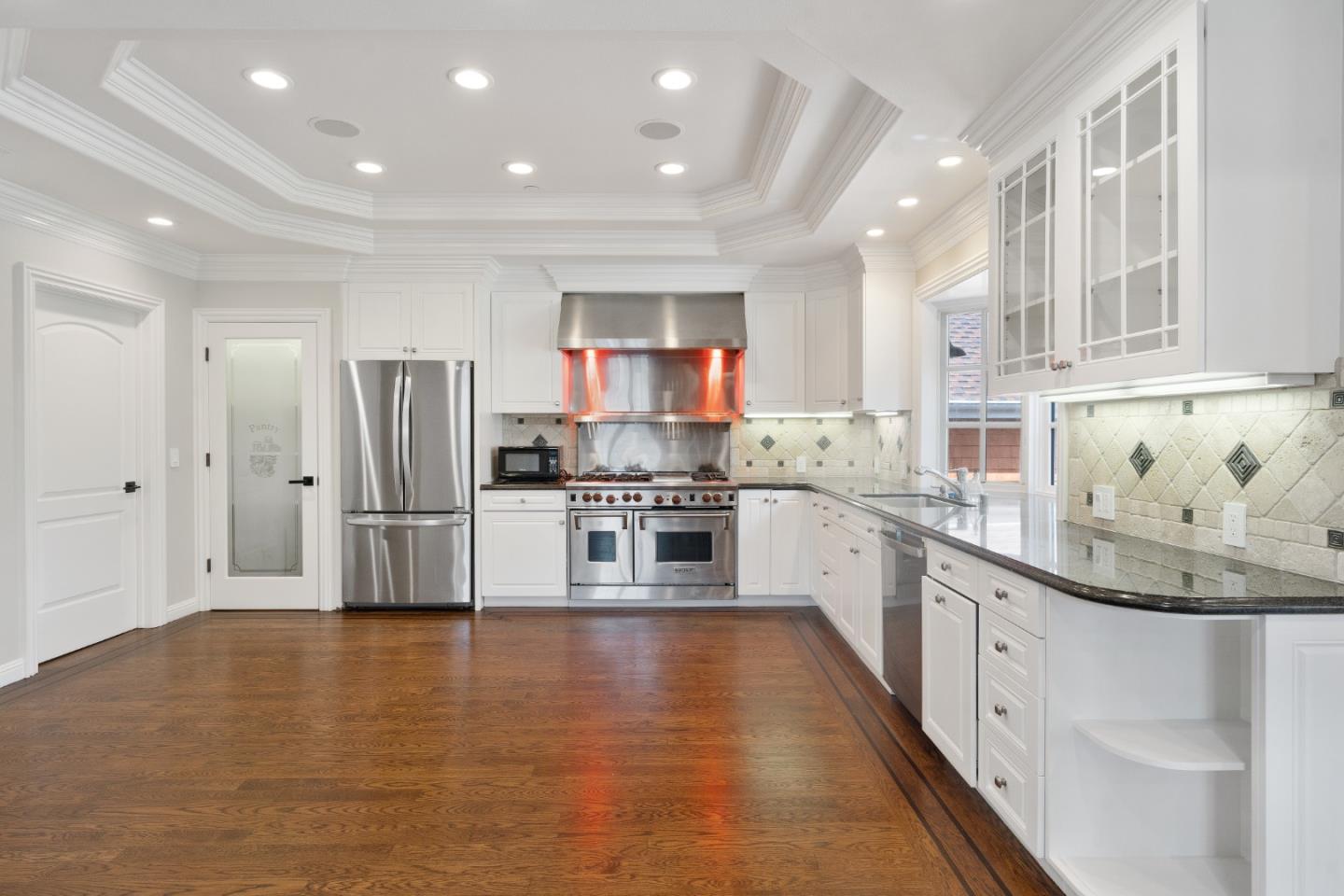 612 Prospect Row San Mateo, CA 94401 - Photo 19 of 54 a large kitchen with stainless steel appliances granite countertop a lot of counter space and wooden floor