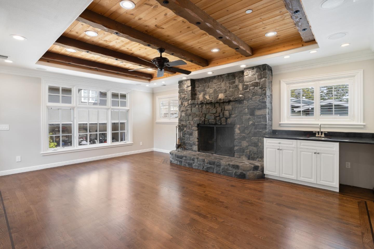 612 Prospect Row San Mateo, CA 94401 - Photo 20 of 54 an empty room with windows fireplace and wooden floor