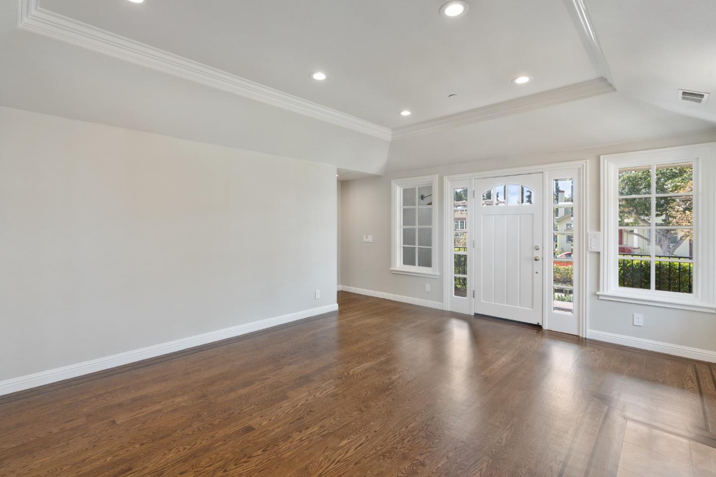 612 Prospect Row San Mateo, CA 94401 - Photo 9 of 54 a view of an empty room with wooden floor and windows
