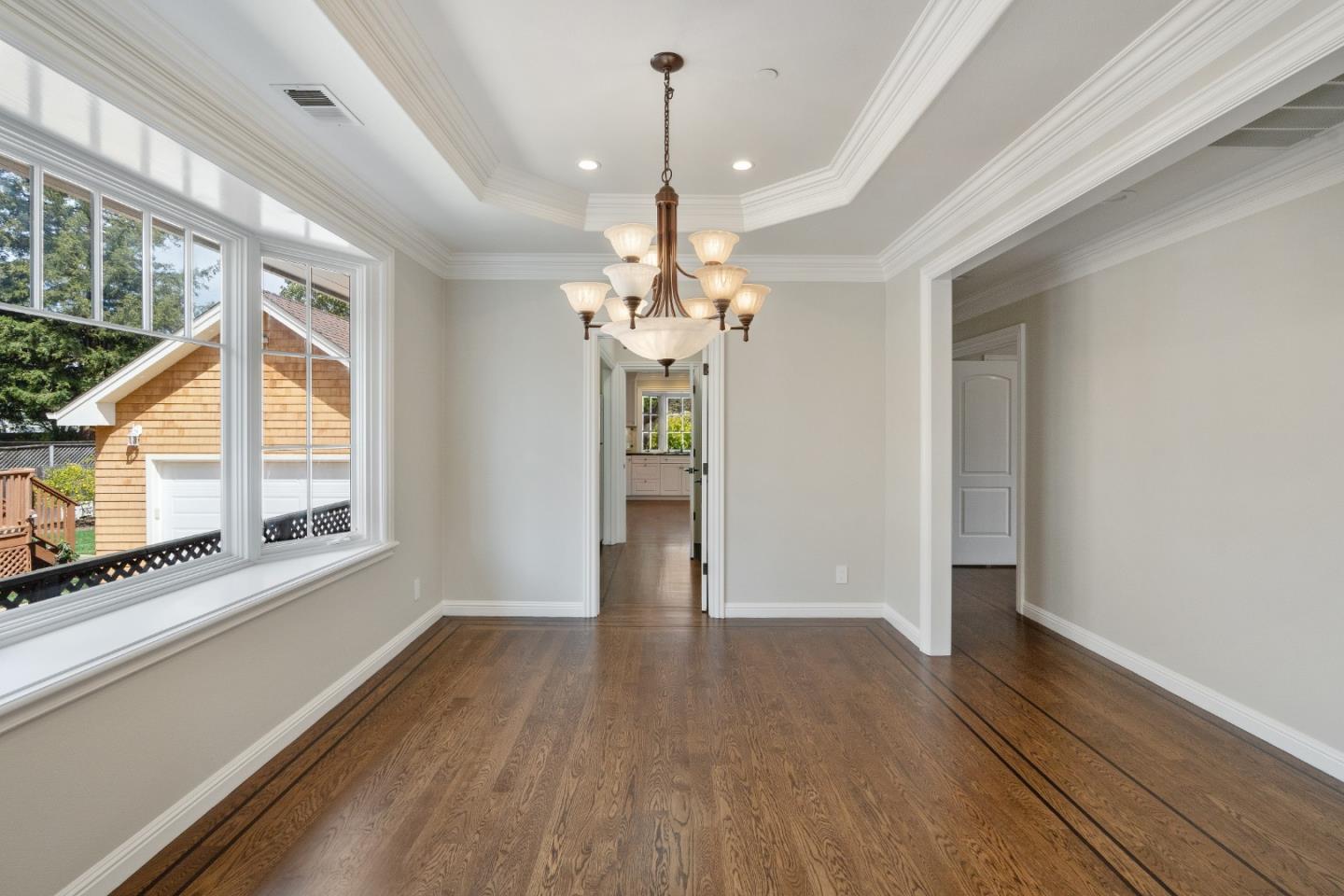 612 Prospect Row San Mateo, CA 94401 - Photo 10 of 54 a view of an empty room with wooden floor and a window