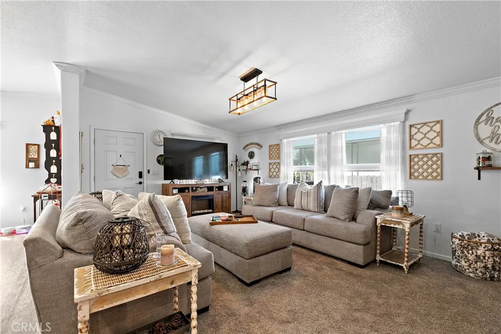 8651 Foothill, Unit 82 Rancho Cucamonga, CA 91730 - Photo 16 of 56 a living room with furniture and a flat screen tv